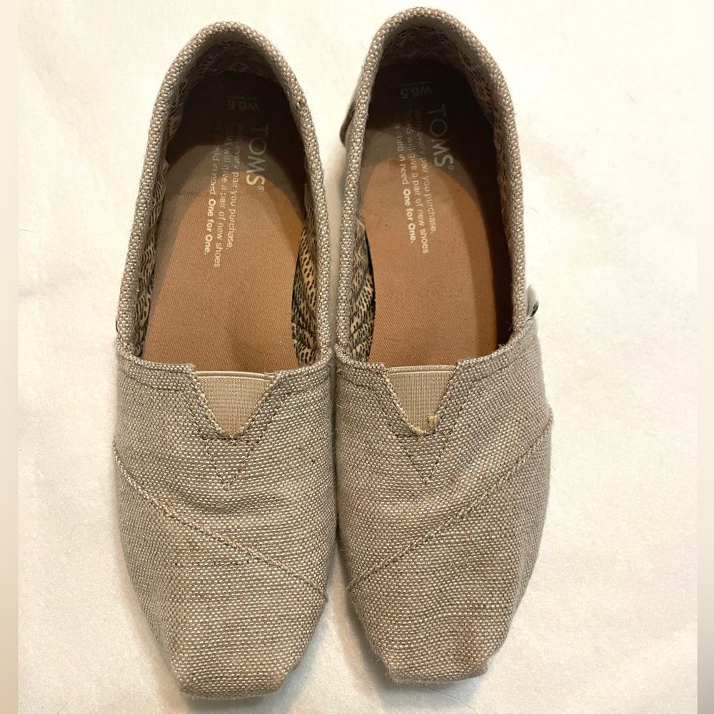 Natural metallic Tom slip ons